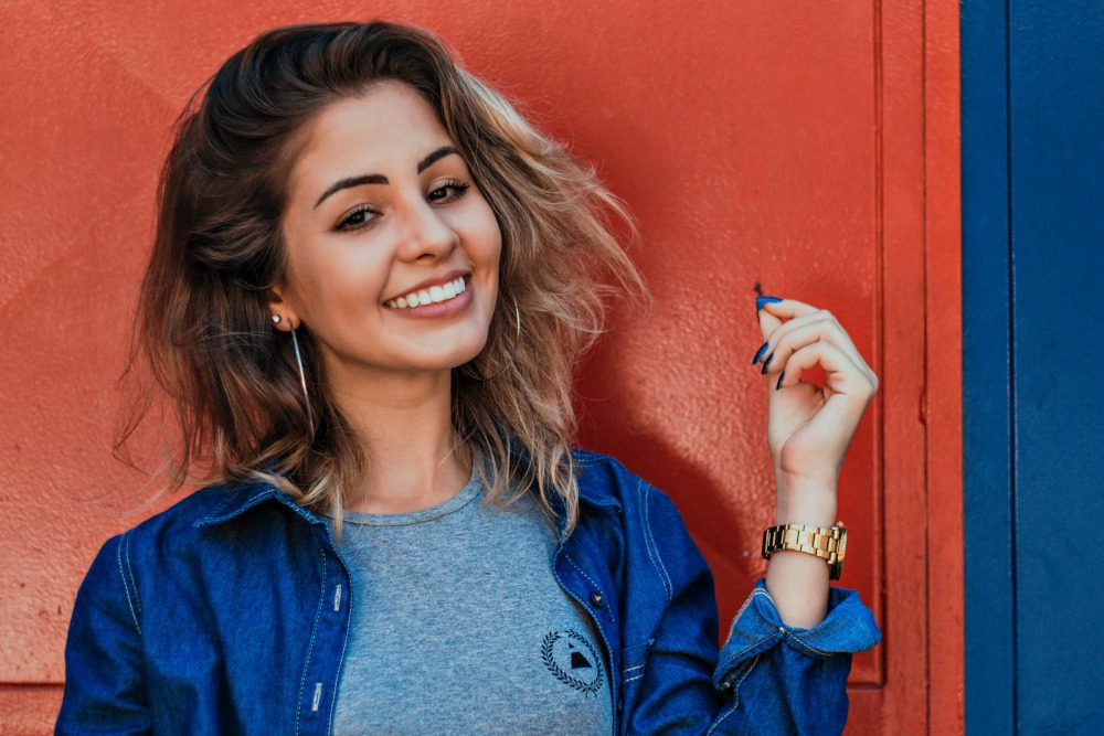 Beautiful woman wearing blue button down shirt.